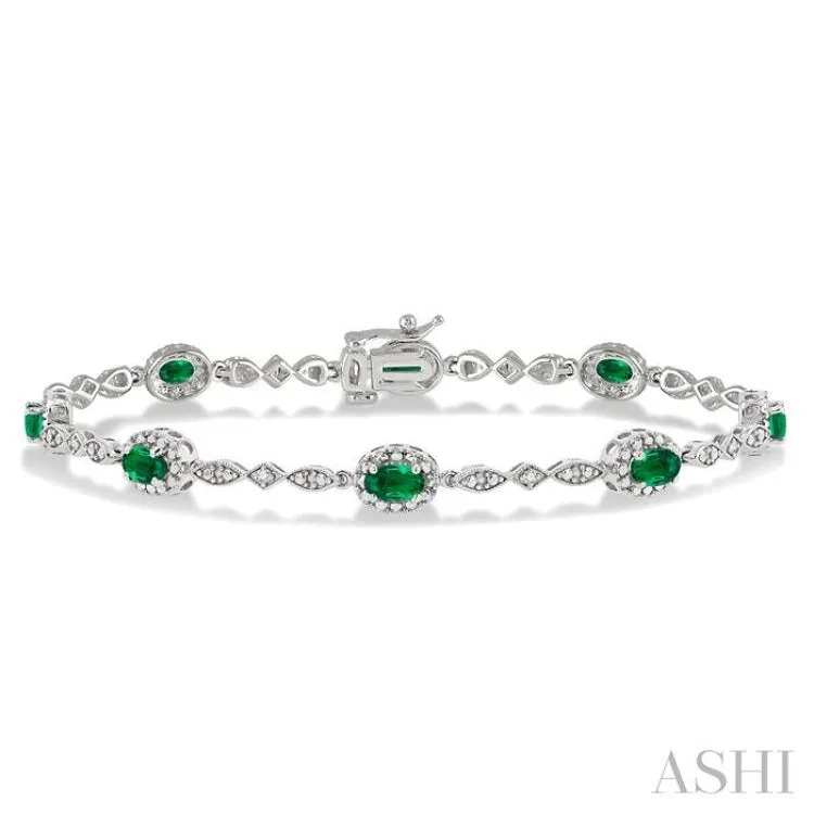 5x3MM Oval Cut Emerald and 1/20 Ctw Single Cut Diamond Bracelet in 10K White Gold